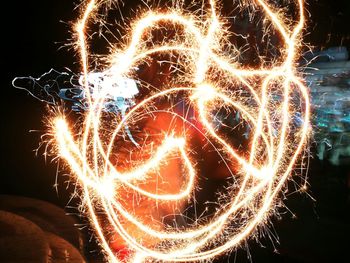 Low angle view of firework display at night