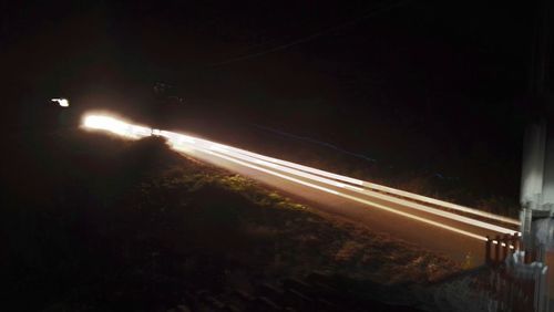 High angle view of light trails on road at night