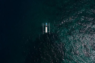 Lighthouse by sea against star field