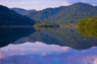 Scenic view of lake and mountains against sky