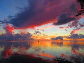 Scenic view of dramatic sky over lake during sunset