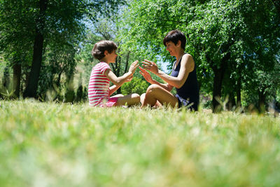 Mother and daughter playing on field