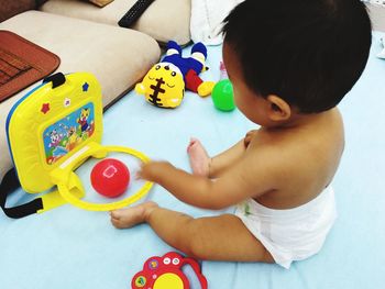 High angle view of boy playing with toy at home