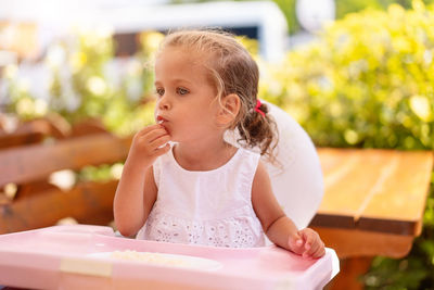 Cute girl eating on table