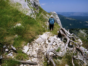 Man standing on rocks against mountains