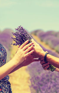 Woman holding purple flower