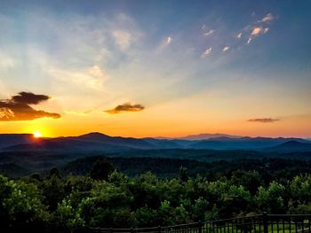 Scenic view of silhouette mountains against sky at sunset