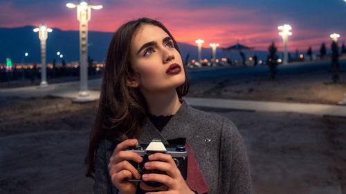 Portrait of young woman looking at camera