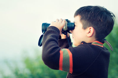 Close-up of boy using binoculars