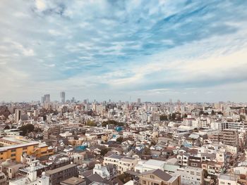 Aerial view of cityscape against sky