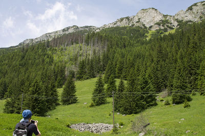 Rear view of person in mountains against sky