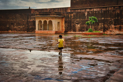 Full length of a boy standing in water