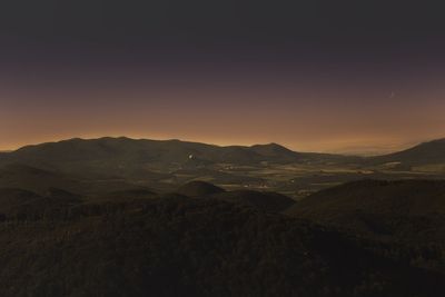 Scenic view of silhouette mountains against sky at sunset