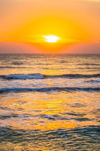 Scenic view of sea against orange sky