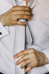 Midsection of man wearing hat