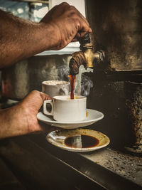 Cropped hand of man holding coffee