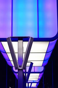 Low angle view of illuminated building against blue sky