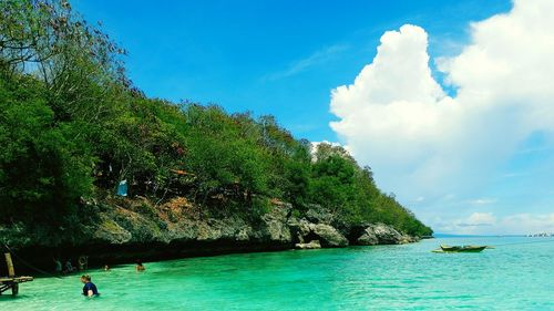 Scenic view of sea against blue sky