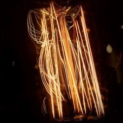 Close-up of illuminated lights against black background