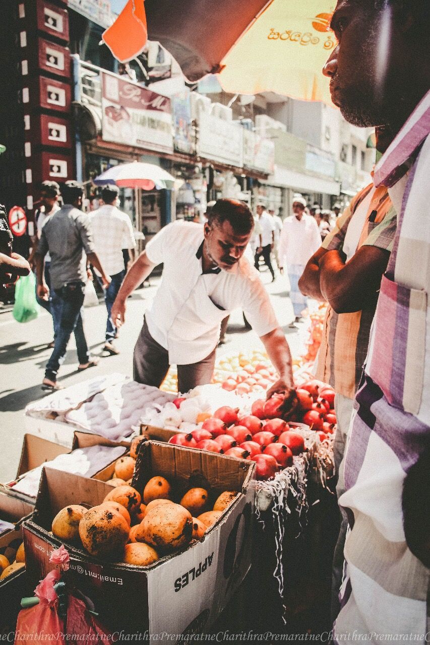 food, food and drink, fruit, city, market, incidental people, healthy eating, retail, freshness, market stall, vegetable, men, real people, business, street, day, architecture, selling, for sale, buying, outdoors, street market, sale