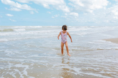 Side view of girl standing at beach