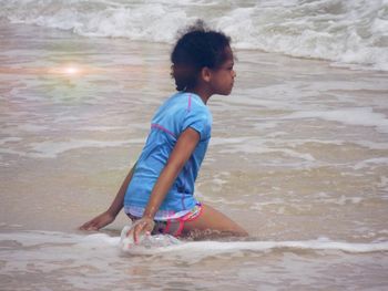 Side view of boy at beach