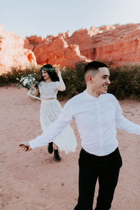 Rear view of couple standing on land