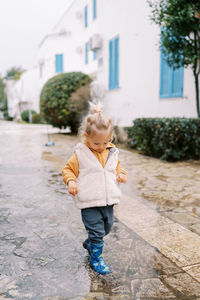 Portrait of cute girl walking on street