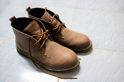 High angle view of shoes on tiled floor