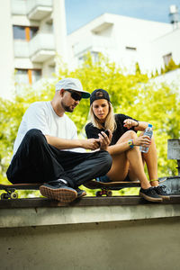 Young couple sitting outdoors