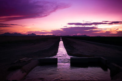 Scenic view of land against sky during sunset