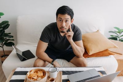 Young woman using laptop at home