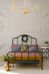 A bed with pink dusty linens and grey pillows in a scandinavian or classic style
