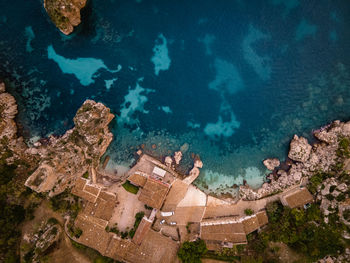 High angle view of buildings by sea