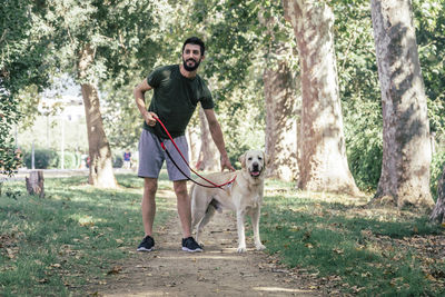 Man with dog relaxing in the forest