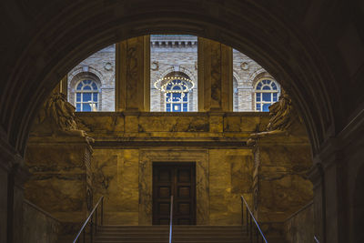 Interior entrance to the boston public library with arched windows. steps to go up