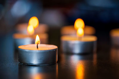 Close-up of burning candles in temple