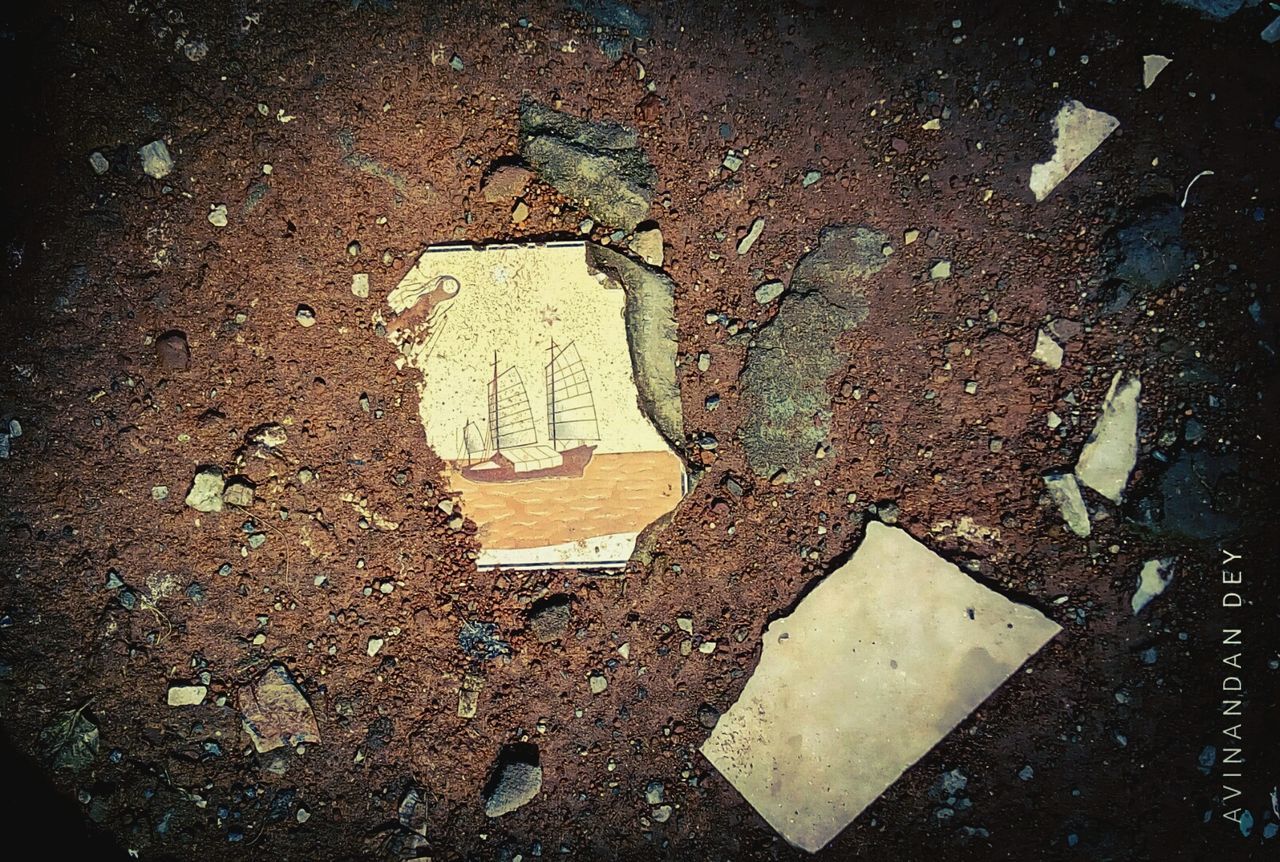 HIGH ANGLE VIEW OF WET ROAD SIGN