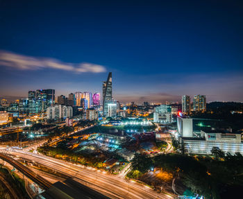 High angle view of illuminated buildings against sky at night