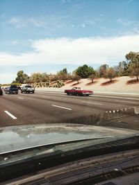 Cars on road against sky