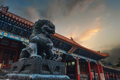 Low angle view of statue against cloudy sky