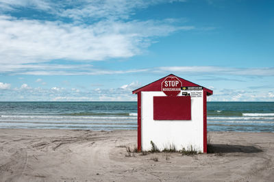 A closed toll booth on a deserted beach photographed early on a sunny morning, lake huron.