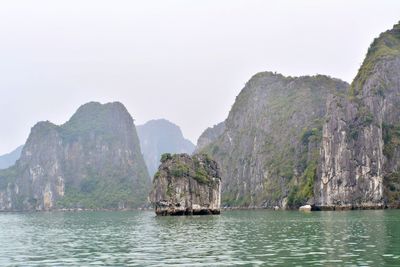 Scenic view of rocks in sea against clear sky in vietnam