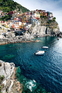 Scenic view of sea by buildings in city