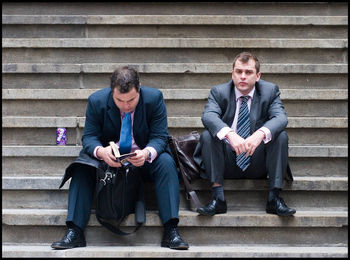 Young men sitting in park