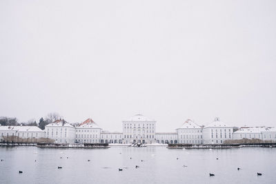 Cranes against sky during winter