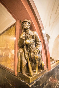 Low angle view of statue against wall in building