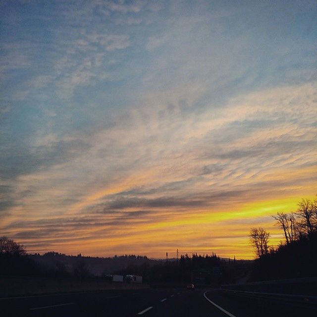 sunset, sky, silhouette, tranquil scene, scenics, tranquility, beauty in nature, orange color, cloud - sky, landscape, nature, road, tree, transportation, dramatic sky, idyllic, cloud, the way forward, outdoors, no people