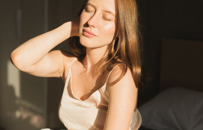 Portrait of young woman sitting at home