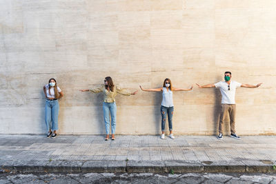 Group of people standing against the wall